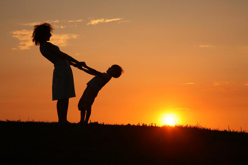 Mother And Son On Sunset Holding By Hands Фотография, картинки, изображения и сток-фотография без роялти. Image 5106098.